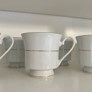 Vintage white ceramic tea cups with gold detailing